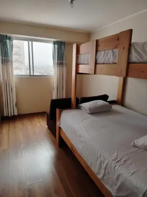 a bedroom with two bunk beds and a large window at Departamento Executive 2BR Balcón Frente al Mall Santa Catalina in Lima
