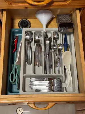 a drawer filled with utensils in a cabinet at Edificio Sir William - Punta hermosa - Lima, Peru in Punta Hermosa