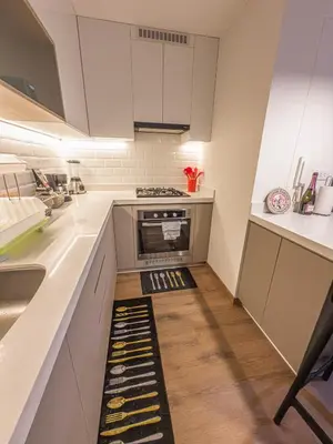 a kitchen with white cabinets and a kitchen floor with an oven at Brand new apartment in the heart of Miraflores in Lima