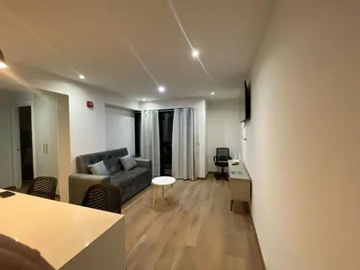 a living room with a couch and a table at Brand new apartment in the heart of Miraflores in Lima