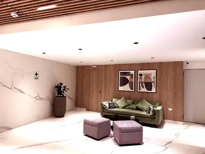 a living room with a couch and two stools at Brand new apartment in the heart of Miraflores in Lima