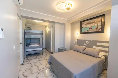 a hotel room with a bed and a bedroom with a bed sqor at Hostal 3 Lunas in Paracas