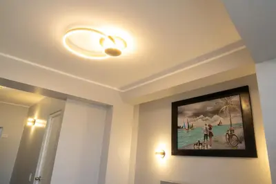 a bathroom with a painting on the ceiling with a light at Hostal 3 Lunas in Paracas