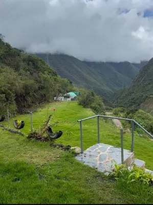a view of a field with mountains in the background at AndeStay Hostel Chaullay in Colcapampa