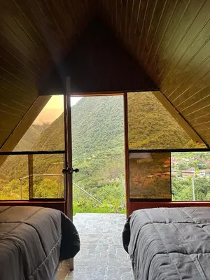 a bedroom with a view of a mountain at AndeStay Hostel Chaullay in Colcapampa