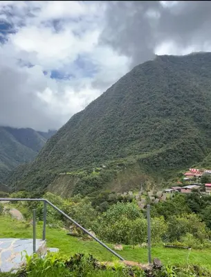 a view of a mountain with a town on it at AndeStay Hostel Chaullay in Colcapampa
