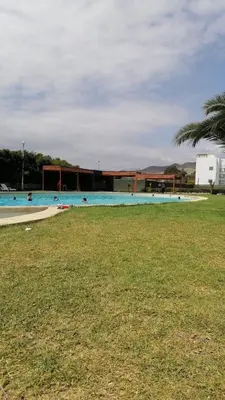a large swimming pool with a building in the background at Asia soleil in Asia