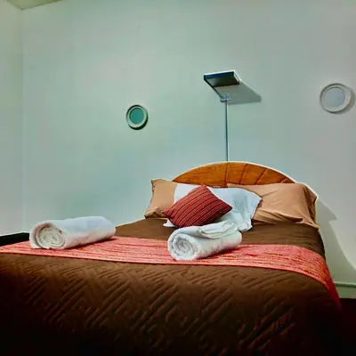 a bedroom with a bed with towels on it at Tres Reyes Hospedaje in Cusco