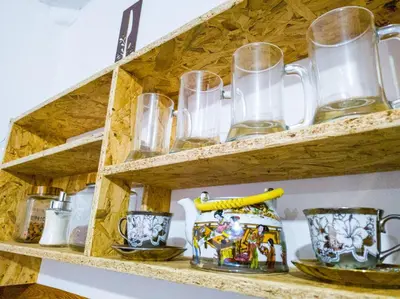 a wooden shelf with glasses and cups on it at Tres Reyes Hospedaje in Cusco
