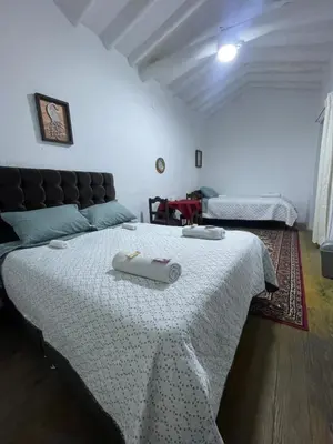 a bedroom with a bed with two towels on it at Tres Reyes Hospedaje in Cusco