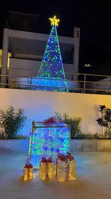 a christmas tree with presents in front of it at Casa de Campo Las Siete Gotas - Cieneguilla in Cieneguilla