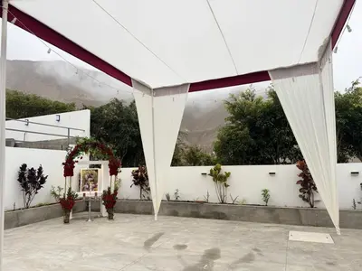 a marquee with a white fence and flowers at Casa de Campo Las Siete Gotas - Cieneguilla in Cieneguilla