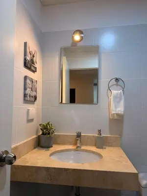 a bathroom with a sink and a mirror at Private cinema & comfort in cultural Barranco in Lima