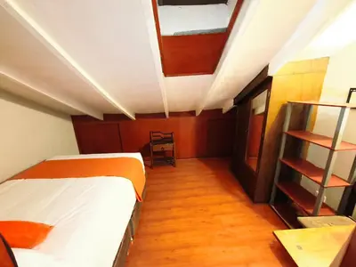 a small room with a bed and a book shelf at Mayu House Inn V en el Centro Historico in Cusco