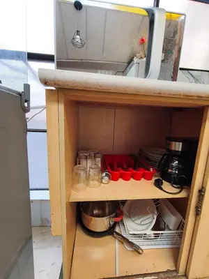 a cupboard with dishes and utensils in a kitchen at Mayu House Inn V en el Centro Historico in Cusco