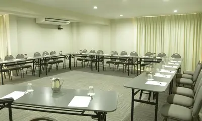 a conference room with tables and chairs with glasses on them at Hotel San Remo in Lima