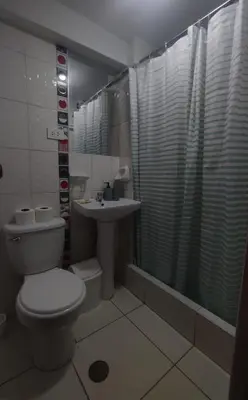 a bathroom with a toilet and a sink at Hermozo Cusco-Calle Fierro in Cusco