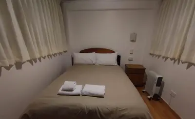 a bedroom with a bed with two towels on it at Hermozo Cusco-Calle Fierro in Cusco