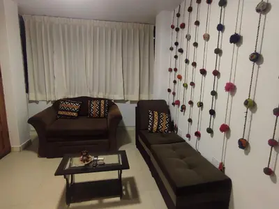 a living room with a couch and a table at Hermozo Cusco-Calle Fierro in Cusco