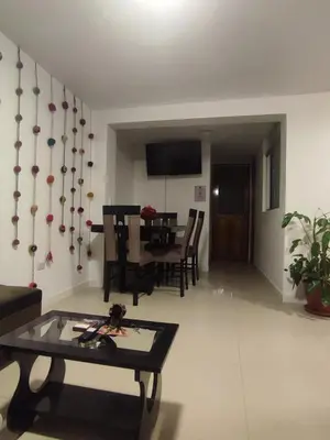 a living room with a table and a dining room at Hermozo Cusco-Calle Fierro in Cusco