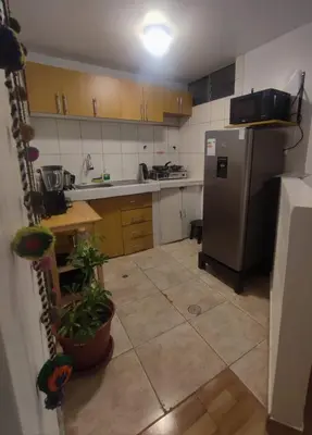 a kitchen with a stainless steel refrigerator in it at Hermozo Cusco-Calle Fierro in Cusco