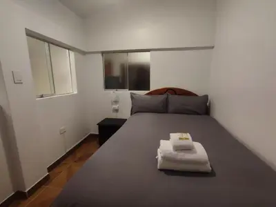 a bedroom with a large bed with towels on it at Hermozo Cusco-Calle Fierro in Cusco