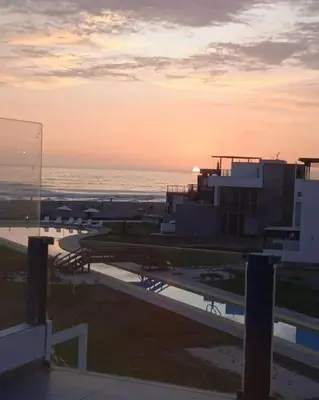 a view of the ocean at sunset from a building at Asia las terrazas casa in Asia