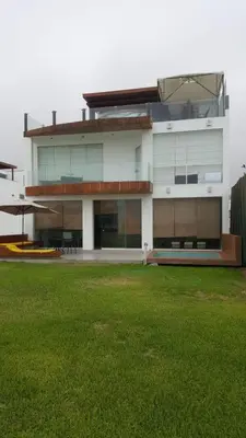 a large white building with a lawn in front of it at Asia las terrazas casa in Asia