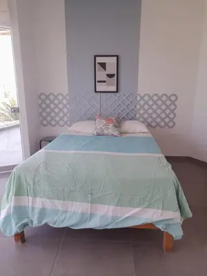 a bedroom with a bed with a blue comforter at Asia las terrazas casa in Asia