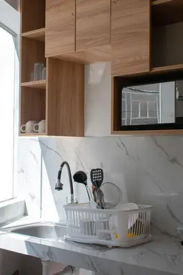 a kitchen counter with a sink with rackets on it at Apart Hotel Alojate Kaypi in Ayacucho