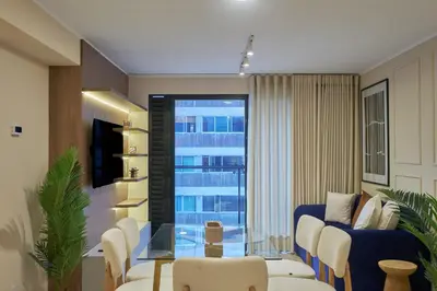 a living room with a couch and a glass table at Larco Prime Suites - Pool, Gym & Coworking in Lima