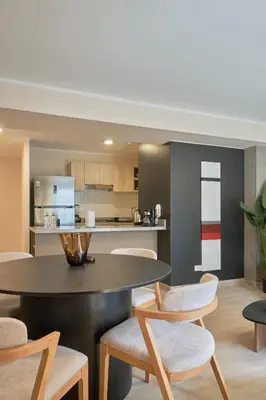 a kitchen and dining room with a table and chairs at Larco Prime Suites - Pool, Gym & Coworking in Lima