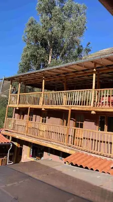 a large wooden building with a large deck at Casa de Campo en el Valle Sagrado de los Incas, Urubamba - Unu Samay in Urubamba