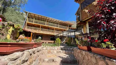 a building with some flowers in front of it at Casa de Campo en el Valle Sagrado de los Incas, Urubamba - Unu Samay in Urubamba
