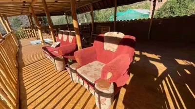 a deck with four red chairs sitting on it at Casa de Campo en el Valle Sagrado de los Incas, Urubamba - Unu Samay in Urubamba