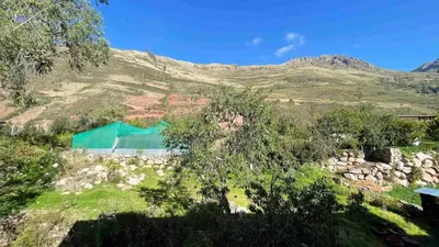 a green tent in the middle of a mountain at Casa de Campo en el Valle Sagrado de los Incas, Urubamba - Unu Samay in Urubamba