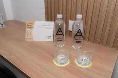 two water bottles and two glasses on a table at Loft en Barranco in Lima