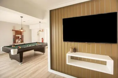 a living room with a pool table and a flat screen tv at Loft en Barranco in Lima
