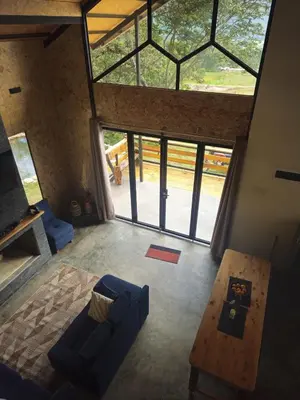 an overhead view of a living room with a large window at La Montaña Lodge - Oxapampa in Oxapampa