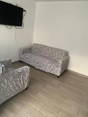 a living room with a couch and a television at Acogedores pisos en el valle de Mala in Mala