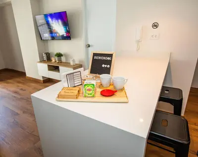 a white counter with two cups and a cutting board at BSR Brand New Apt Near Larcomar w/ Parking & Gym in Lima
