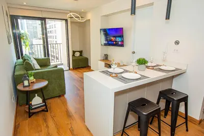 a kitchen and living room with a bar in a apartment at BSR Brand New Apt Near Larcomar w/ Parking & Gym in Lima