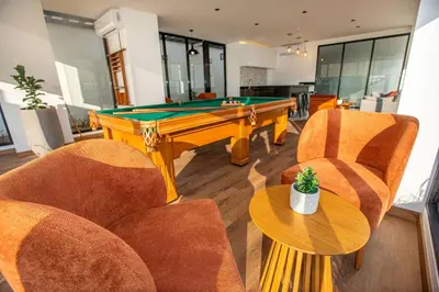 a living room with a pool table and chairs at BSR Brand New Apt Near Larcomar w/ Parking & Gym in Lima