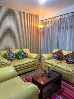 a living room with two couches and a coffee table at Apartamento Quillque House in Cusco