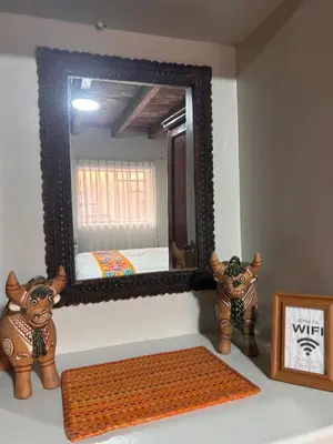 a mirror sitting on top of a counter with a rug at Apartamento Quillque House in Cusco