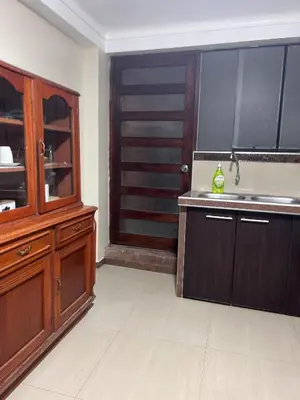 a kitchen with a sink and a wooden cabinet at Apartamento Quillque House in Cusco