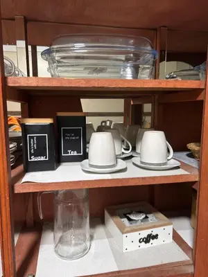 a shelf with plates and cups and a vase at Apartamento Quillque House in Cusco