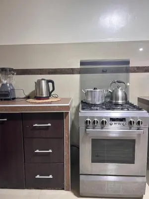 a kitchen with two pots and pans on a stove at Apartamento Quillque House in Cusco