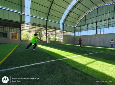 a group of people playing soccer in a building at Nuevo campo verde eirl in Lima