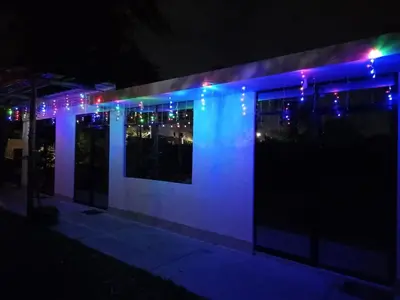 a building with blue and purple lights on it at Casa rústica in Ica